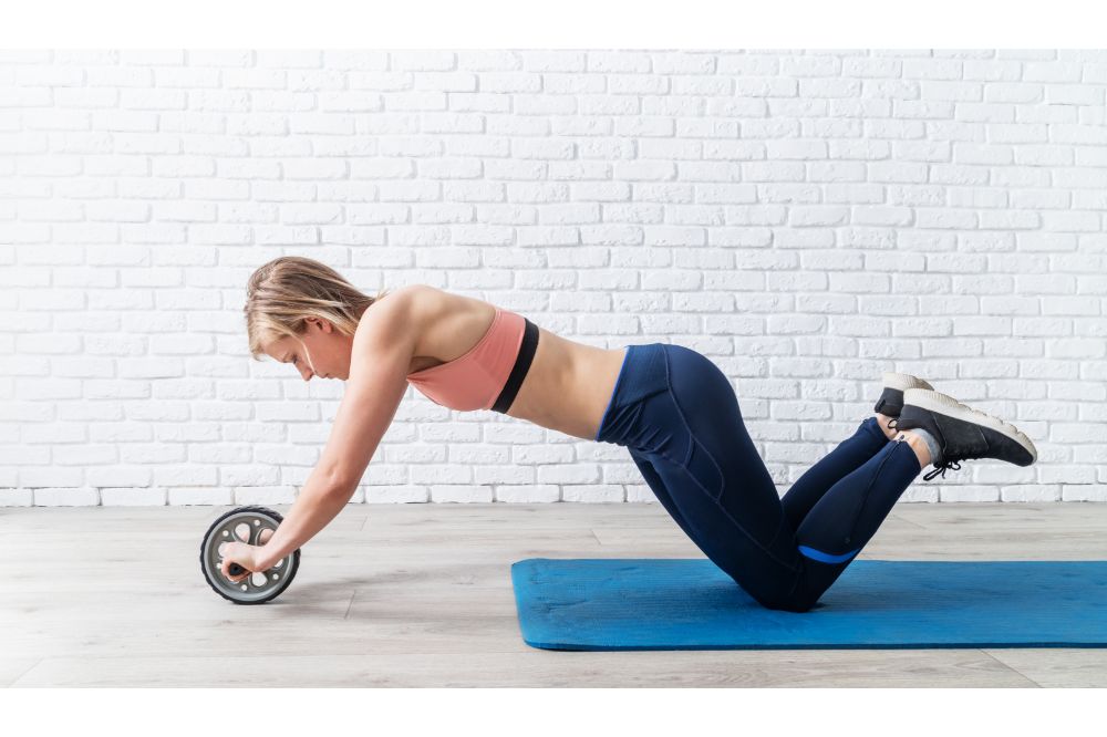 woman doing abdominal exercises with gymnastic roller